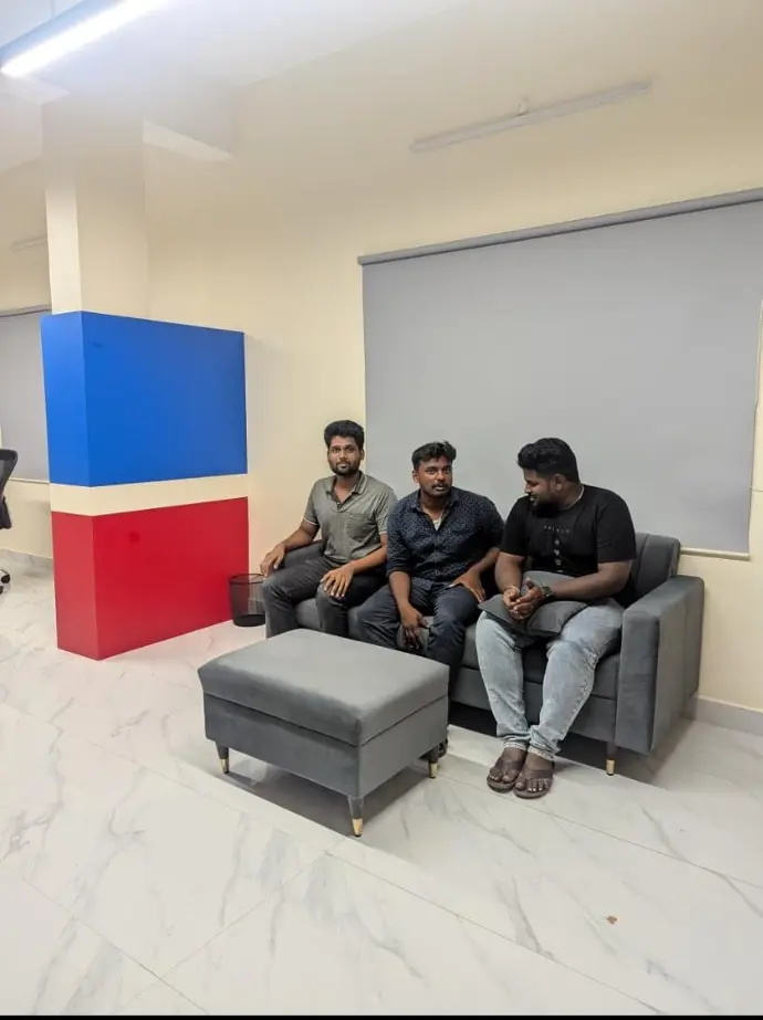 Team members relaxing on the sofa in the Teapot Techies lounge