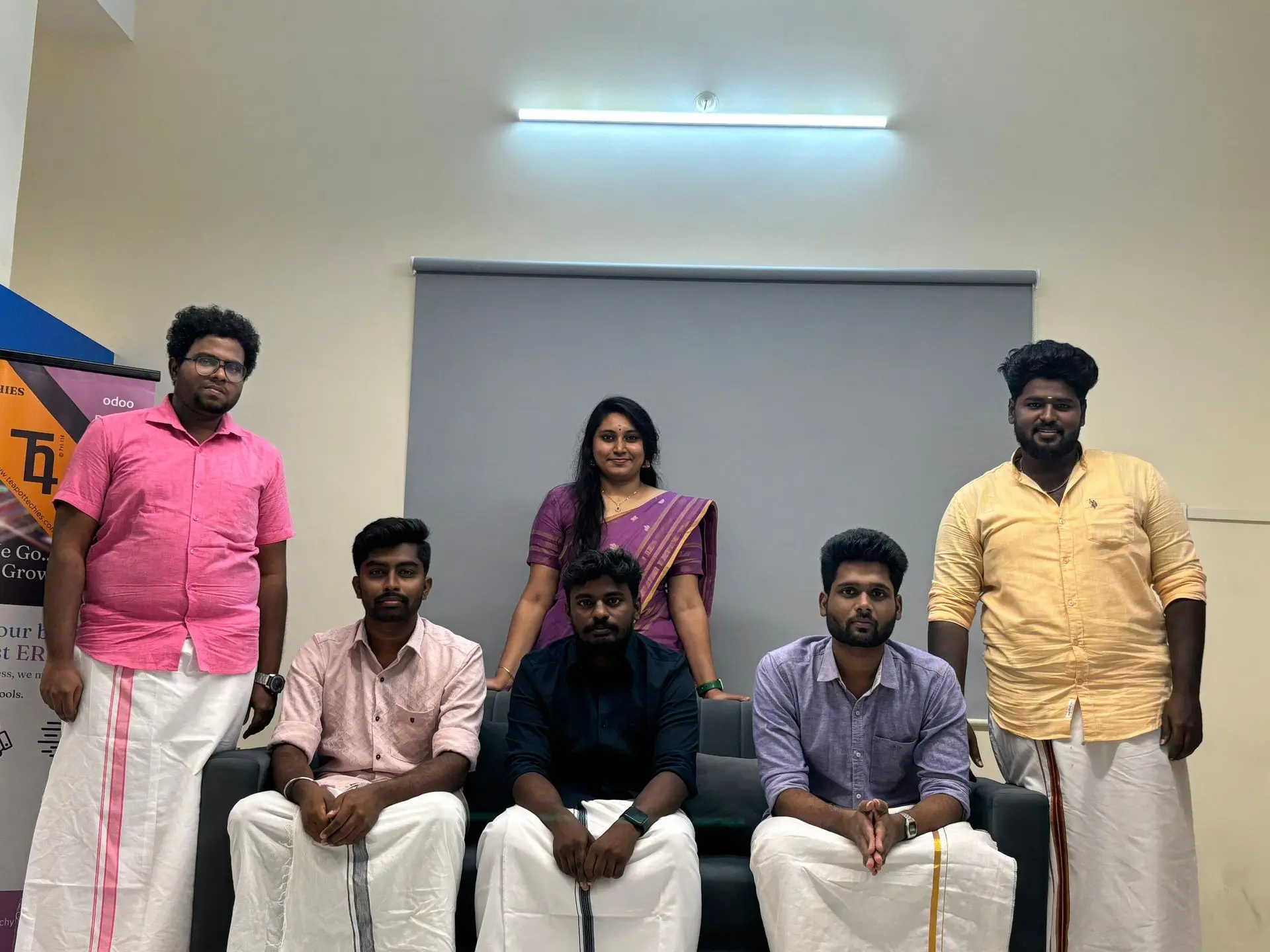The team seated together for a festive group photo