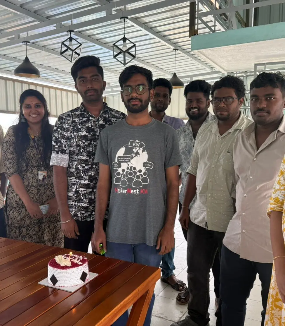 The team around a birthday cake on the terrace