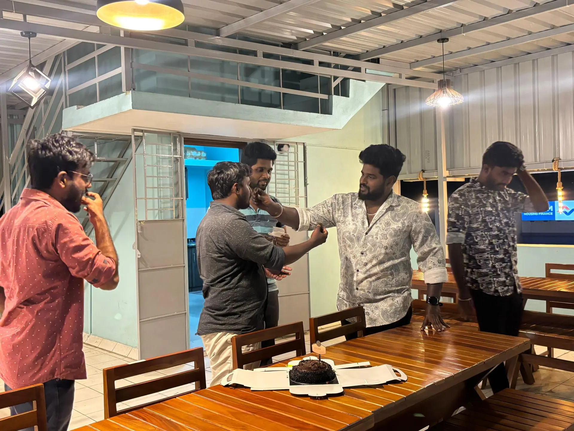 Teammates sharing a light moment at the terrace table