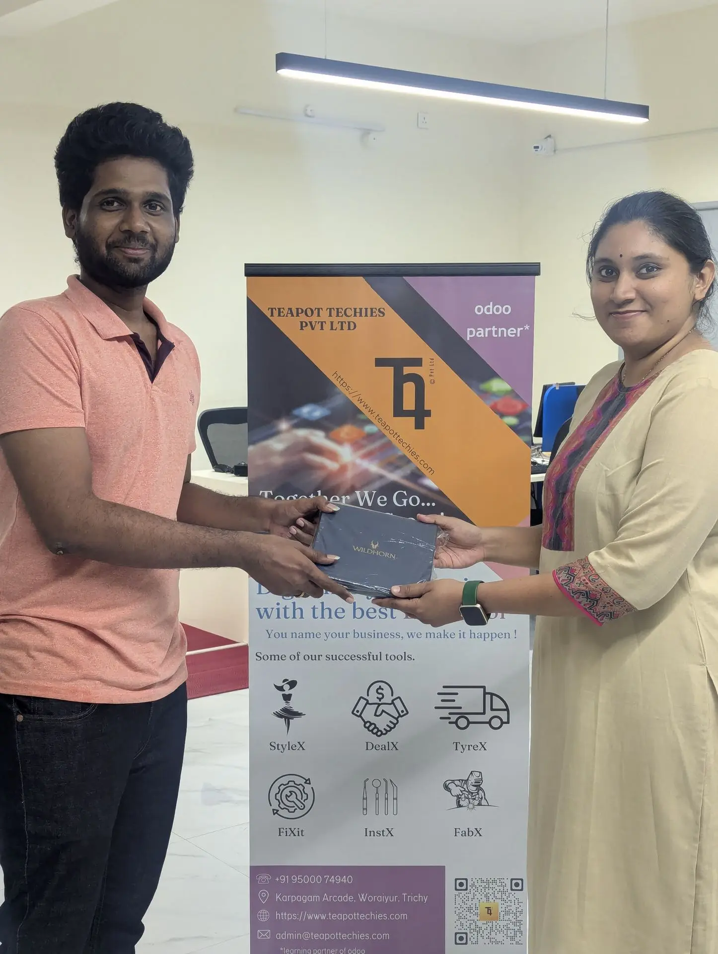 A teammate receiving a memento from the Managing Director