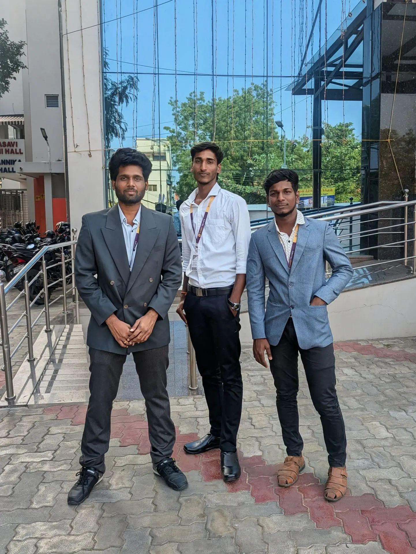 Three teammates in business attire outside the office building